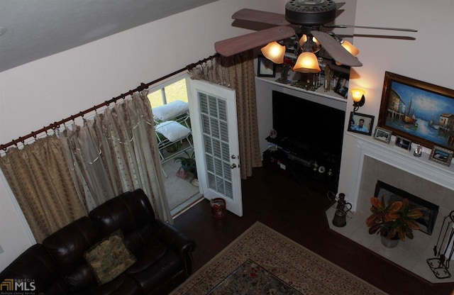 living room featuring dark hardwood / wood-style floors and ceiling fan