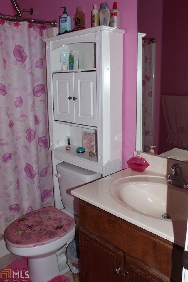 bathroom featuring vanity, a shower with shower curtain, and toilet