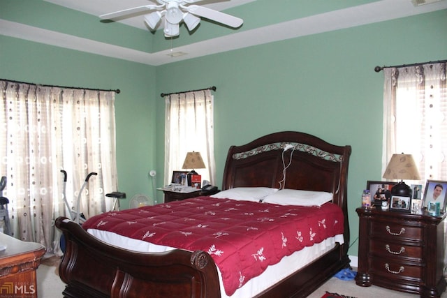 bedroom with multiple windows and ceiling fan