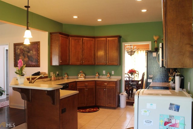 kitchen featuring pendant lighting, a breakfast bar, and kitchen peninsula