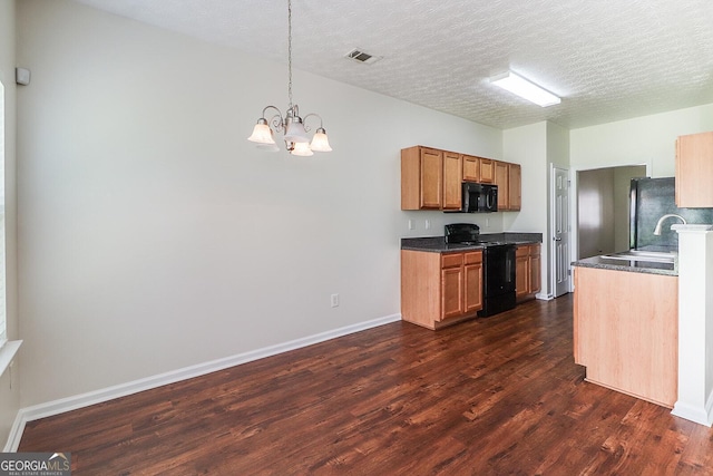 kitchen featuring a textured ceiling, a notable chandelier, black appliances, and sink