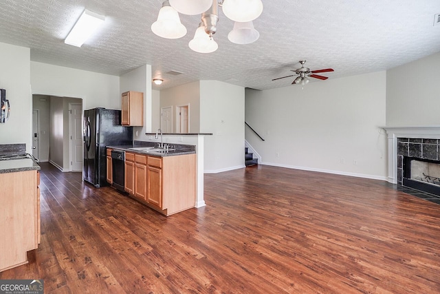 53 Providence Oak Ct, Lawrenceville, GA 30046 - kitchen with open floor plan, dark countertops, dark wood-style floors, black appliances, and a textured ceiling