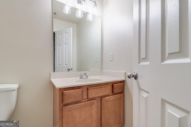 bathroom featuring toilet and vanity