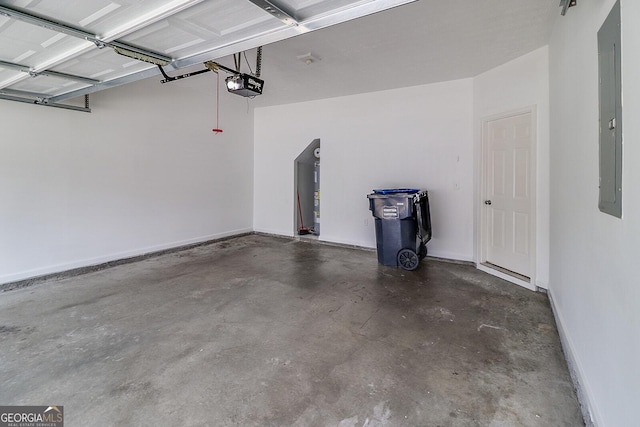 garage featuring electric panel and a garage door opener