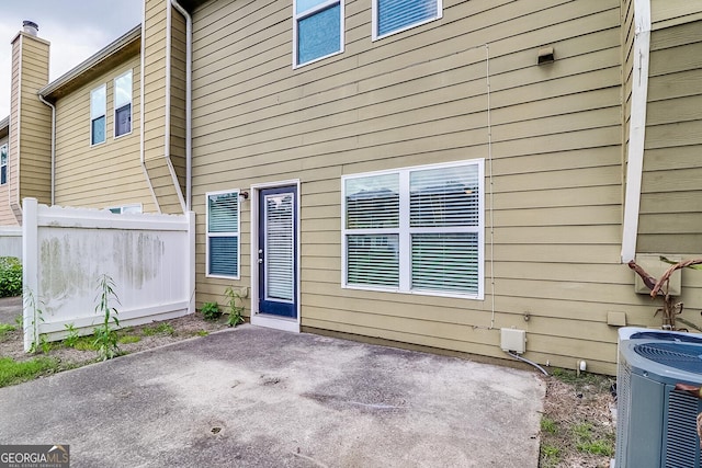 back of property featuring central AC and a patio area