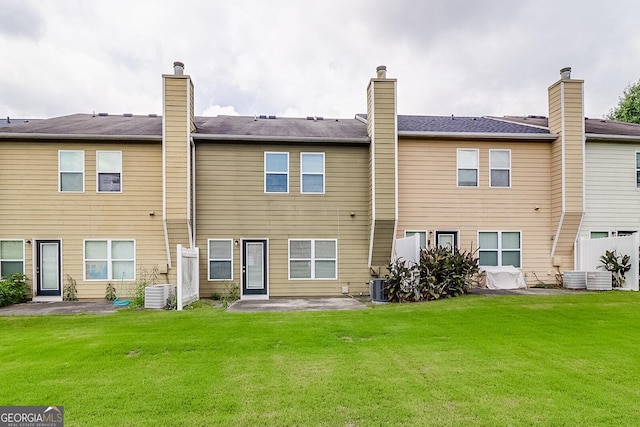 back of property featuring a patio, central AC, and a lawn