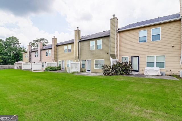 rear view of house with a lawn