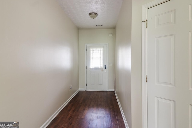 entryway featuring dark hardwood / wood-style flooring and a textured ceiling