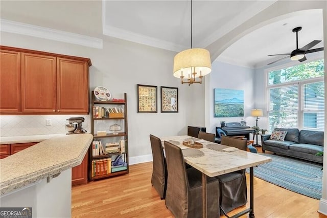 dining room with ceiling fan, light hardwood / wood-style floors, and ornamental molding