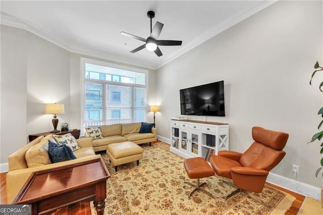 living room with hardwood / wood-style flooring, ceiling fan, and ornamental molding