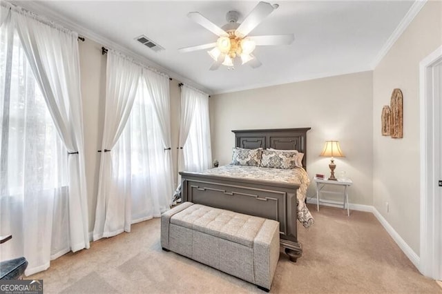 carpeted bedroom featuring ceiling fan and ornamental molding