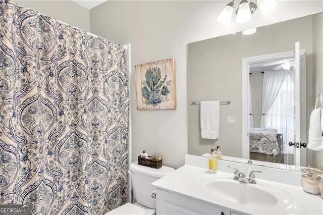 bathroom featuring vanity and toilet