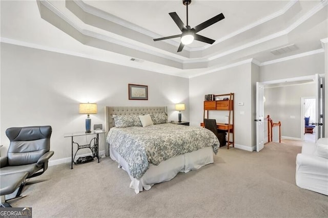 carpeted bedroom with a raised ceiling, ceiling fan, and crown molding