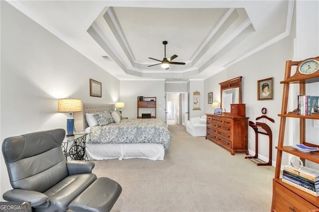 bedroom featuring ceiling fan, a raised ceiling, crown molding, and light carpet