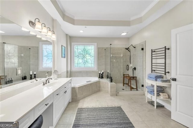 bathroom featuring tile patterned flooring, vanity, a tray ceiling, and plus walk in shower