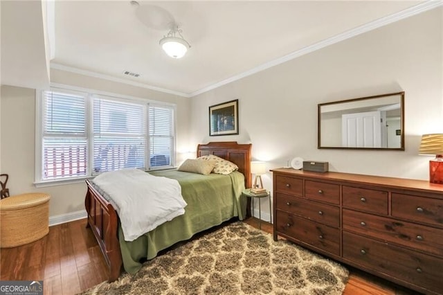 bedroom with ornamental molding and dark wood-type flooring