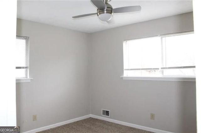 empty room featuring carpet flooring and ceiling fan