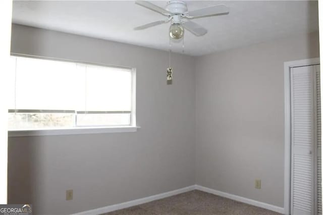 unfurnished bedroom featuring carpet flooring, ceiling fan, and a closet