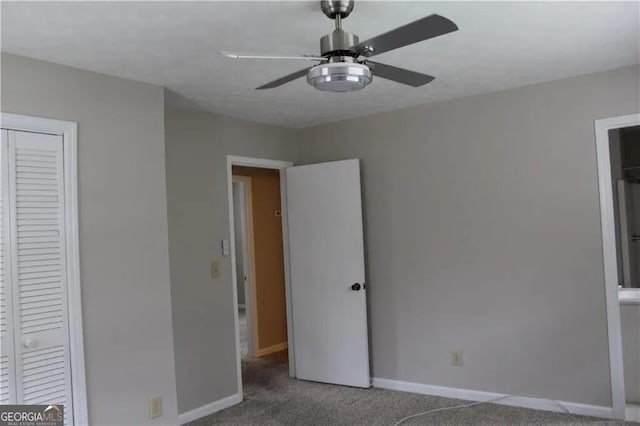 unfurnished bedroom with carpet flooring, ceiling fan, and a closet