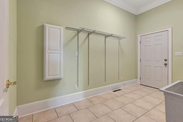 interior space featuring ornamental molding and light tile patterned floors