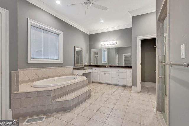 bathroom featuring tile patterned floors, ornamental molding, vanity, ceiling fan, and tiled tub