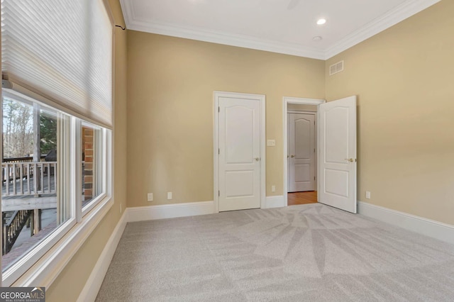 unfurnished bedroom featuring light carpet and ornamental molding