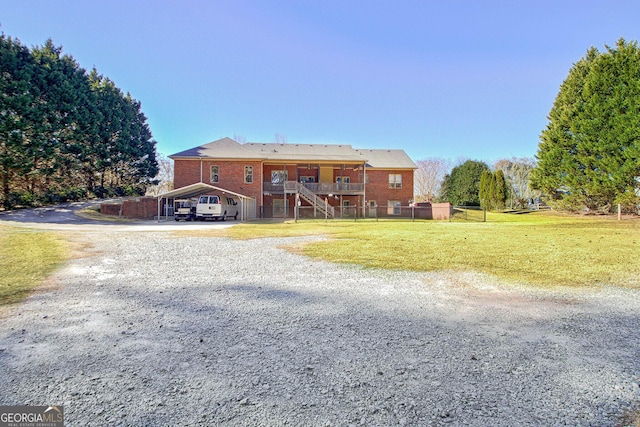 view of front facade with a front yard and a carport