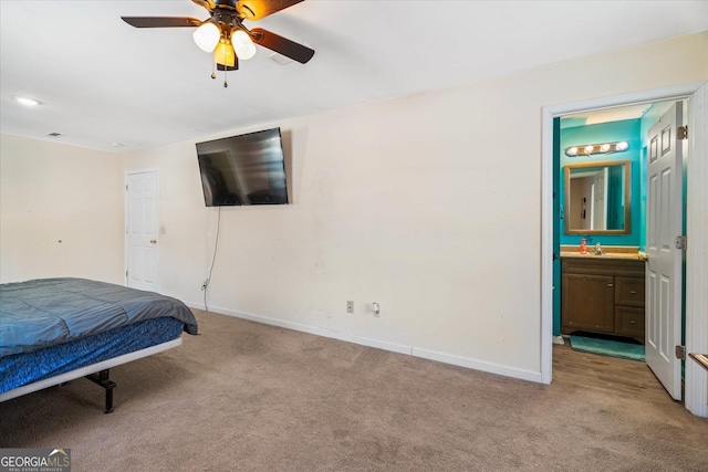 carpeted bedroom featuring ceiling fan and ensuite bathroom