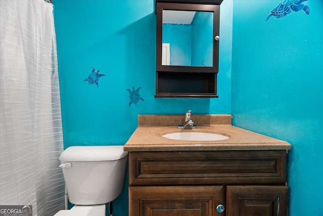 bathroom featuring vanity and toilet