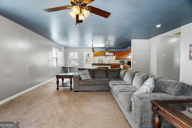 carpeted living room featuring ceiling fan