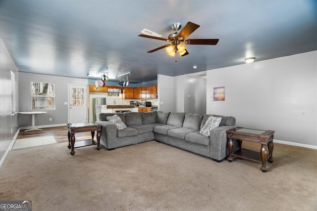 carpeted living room featuring ceiling fan