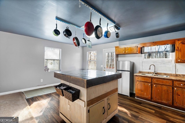 kitchen featuring stainless steel fridge and sink