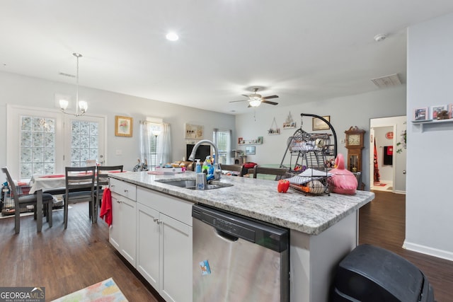 kitchen featuring dishwasher, sink, hanging light fixtures, an island with sink, and white cabinets