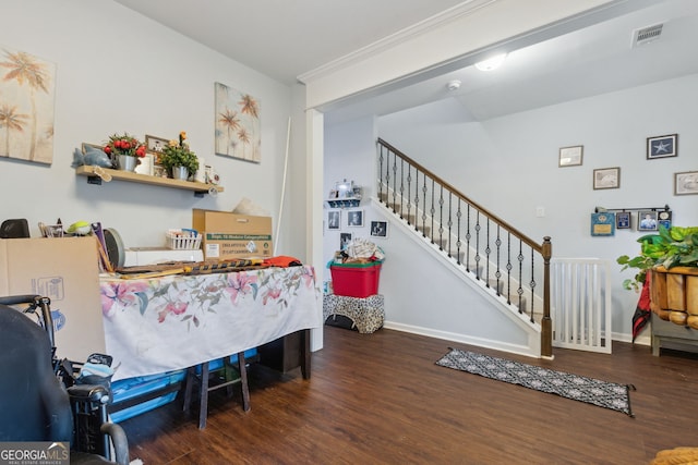 interior space with dark hardwood / wood-style flooring and crown molding