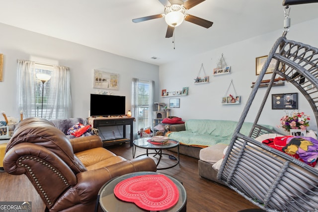 living room with dark hardwood / wood-style floors, ceiling fan, and a healthy amount of sunlight