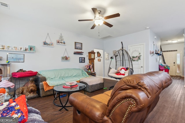 living room featuring ceiling fan and dark hardwood / wood-style floors