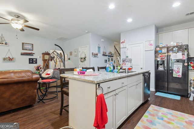 kitchen featuring a center island with sink, white cabinets, sink, dark hardwood / wood-style floors, and appliances with stainless steel finishes