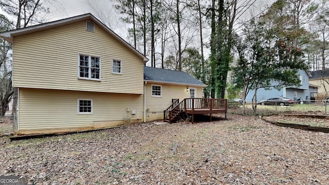 rear view of house featuring a deck