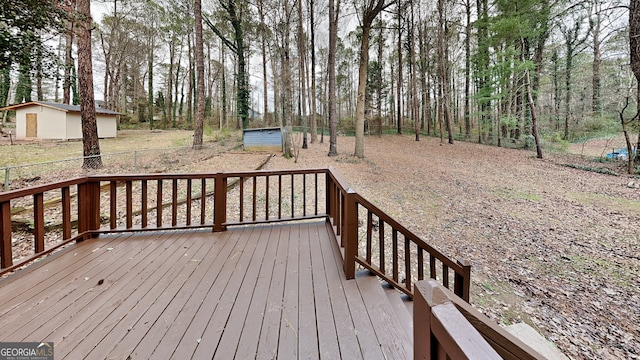 wooden terrace featuring a storage unit