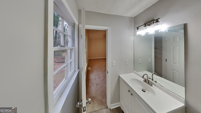 bathroom with vanity and a textured ceiling