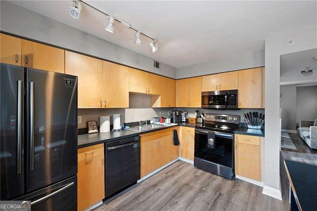 kitchen featuring hardwood / wood-style floors, sink, and stainless steel appliances