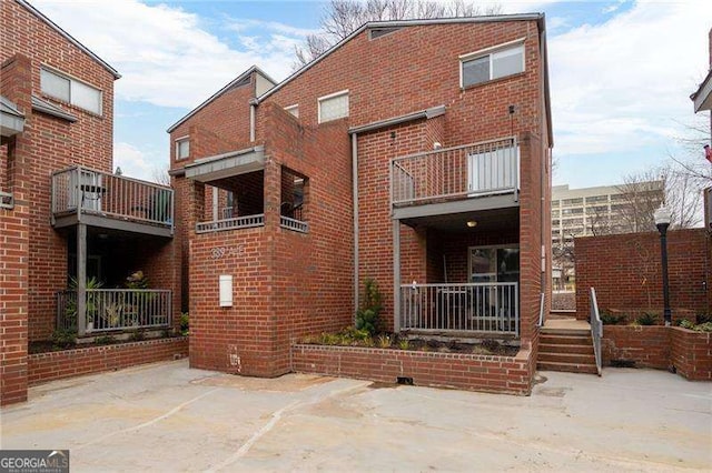 rear view of property with a balcony