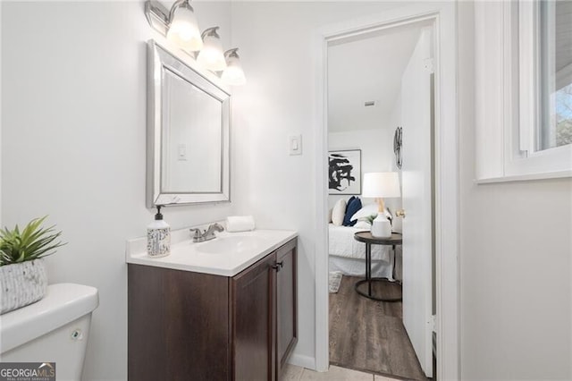 bathroom with tile patterned flooring, vanity, and toilet