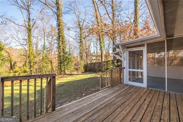 wooden terrace with a sunroom and a yard