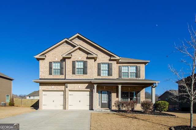 craftsman-style home with driveway, an attached garage, fence, central AC, and brick siding