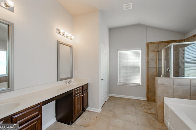 bathroom with tile patterned floors, vanity, a healthy amount of sunlight, and lofted ceiling