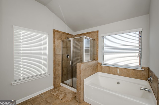 full bathroom featuring a stall shower, a garden tub, vaulted ceiling, and tile patterned floors