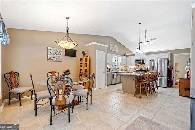 dining room featuring light tile patterned flooring and lofted ceiling