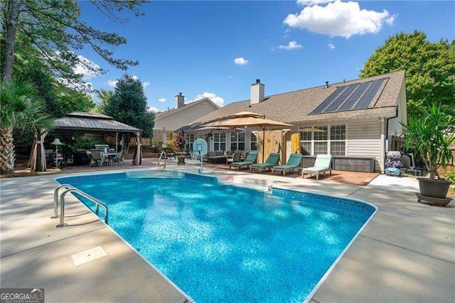 view of swimming pool with a gazebo and a patio area