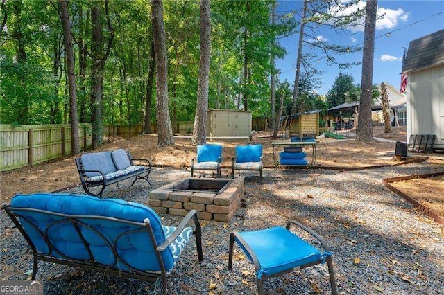 view of patio featuring a storage shed and an outdoor fire pit